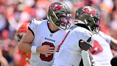 Baker Mayfield, #6 of the Tampa Bay Buccaneers, hands the ball off to Rachaad White #1 of the Tampa Bay Buccaneers