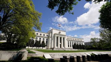 The Federal Reserve building is set against a blue sky in Washington.