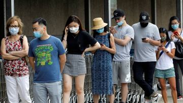 People wear protective face masks outside at a shopping plaza after New Jersey Governor Phil Murphy said he would sign an executive order requiring people to wear face coverings outdoors to prevent a resurgence of the coronavirus disease (COVID-19), in Edgewater, New Jersey, U.S., July 8, 2020. REUTERS/Mike Segar
