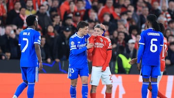 (FILES) SL Benfica's Argentine forward #25 Gianluca Prestianni hides his mouth while arguing with Real Madrid's Brazilian forward #07 Vinicius Junior who complained about alleged racists insults during the UEFA Champions League knockout round play-off first leg football match between SL Benfica and Real Madrid CF at Estadio da Luz in Lisbon on February 17, 2026. UEFA on February 23, 2026 suspended midfielder Gialuca Prestianni from Benfica's Champions League play-off second leg against Real Madrid this week after he was accused of racially abusing Vinicius Junior. (Photo by PATRICIA DE MELO MOREIRA / AFP)