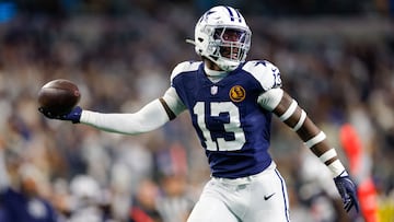 Nov 28, 2024; Arlington, Texas, USA; Dallas Cowboys linebacker DeMarvion Overshown (13) intercepts a pass and returns it for a touchdown during the second quarter against the New York Giants at AT&T Stadium. Mandatory Credit: Andrew Dieb-Imagn Images