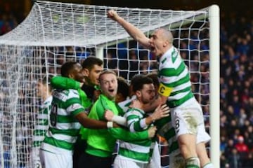 Scott Brown (1st R) of Celtic joins players' celebration after their team's second goal scored by Scott Sinclair during the Ladbrokes Scottish Premiership match between Rangers and Celtic at Ibrox Stadium