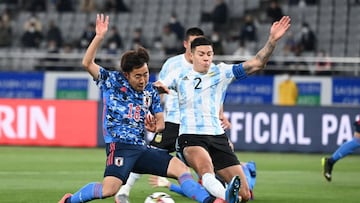 Japan's midfielder Kouta Watanabe (L) and Argentina defender Nehuen Perez (R) fight for the ball during their Under-24 international friendly football match at Ajinomoto Stadium in Tokyo on March 26, 2021. (Photo by Kazuhiro NOGI / AFP)