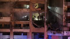 People stand at a damaged building following an explosion at the Beirut suburb of Dahiyeh, Lebanon January 2, 2024. REUTERS/Mohamed Azakir