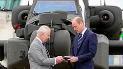 Britain's King Charles III officially hands over the role of Colonel-in-Chief of the Army Air Corps to Prince William, Prince of Wales, in front of a helicopter at the Army Aviation Centre in Middle Wallop, Britain May 13, 2024. Kin Cheung/Pool via REUTERS