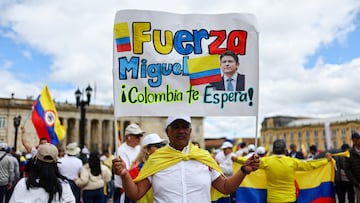 A man holds a sign as he attends a silent march after the attack on Colombian Senator Miguel Uribe Turbay of the opposition Democratic Center party, in Bogota, Colombia, June 15, 2025. REUTERS/Luisa Gonzalez