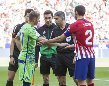 Los capitanes Joaquín y Godín con el árbitro Undiano Mallenco antes del comienzo del partido. 