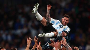 Argentina's striker Lionel Messi is thrown into the air by his teammates as they celebrate their win on the pitch after the 'Finalissima' International friendly football match between Italy and Argentina at Wembley Stadium in London on June 1, 2022. - The Azzurri face the South American continental champions in the inaugural Finalissima at Wembley. (Photo by Adrian DENNIS / AFP) (Photo by ADRIAN DENNIS/AFP via Getty Images)