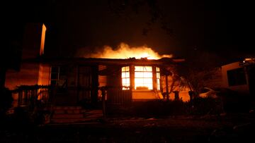 Flames rise from a building as the Eaton Fire burns in Pasadena, California, U.S. January 8, 2025. REUTERS/Mario Anzuoni