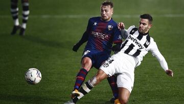 HUESCA, SPAIN - DECEMBER 22: Javi Ontiveros of SD Huesca competes for the ball with Jose Campana of Levante UD during the La Liga Santader match between SD Huesca and Levante UD at Estadio El Alcoraz on December 22, 2020 in Huesca, Spain. (Photo by Eric A