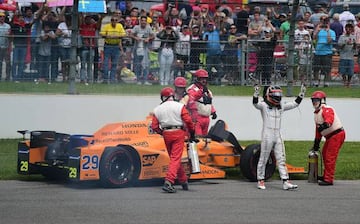 Fernando Alonso leaves his car after his engine failed at the 101st Indianapolis 500.