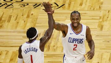 Jan 29, 2021; Orlando, Florida, USA; LA Clippers guard Reggie Jackson (1) and forward Kawhi Leonard (2) celebrate a basket to end the third quarter against the Orlando Magic at Amway Center. Mandatory Credit: Reinhold Matay-USA TODAY Sports