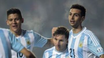 Argentina's midfielder Javier Pastore (R), Argentina's forward Lionel Messi (C) and Argentina's defender Marcos Rojo (L) celebrate a goal against Paraguay during their Copa America semifinal football match in Concepcion, Chile on June 30, 2015. AFP PHOTO / JUAN MABROMATA