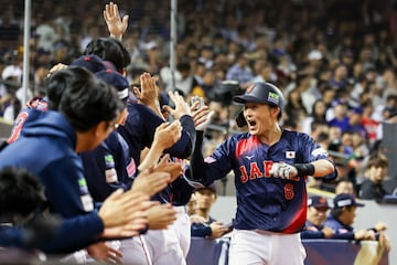 Sosuke Genda is congratulated by teammates after a home run for one point during the WBSC Premier 12 Group B baseball game between Taiwan and Japan 