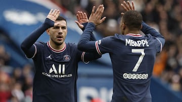 Soccer Football - Ligue 1 - Paris St Germain v Bordeaux - Parc des Princes, Paris, France - March 13, 2022 Paris St Germain's Leandro Paredes celebrates scoring their third goal with Kylian Mbappe REUTERS/Benoit Tessier