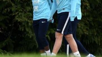 Karim Benzema habla con Patrice Evra durante un entrenamiento de la selección francesa