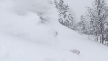 El freerider Aymar Navarro, literalmente sumergido en nieve mientras esquía en la Val d'Aran (Lleida, Catalunya, España) con unos árboles al fondo, el domingo 28 de noviembre del 2021.