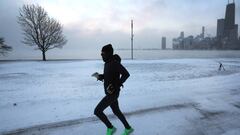 CHICAGO, ILLINOIS - DECEMBER 23: A jogger runs along Lake Michigan at sunrise as temperatures hover about -8 degrees on December 22, 2022 in Chicago, Illinois. Sub-zero temperatures are expected to grip the city for the next couple of days with wind chill temperature dipping as low as -40 degrees.   (Photo by Scott Olson/Getty Images)