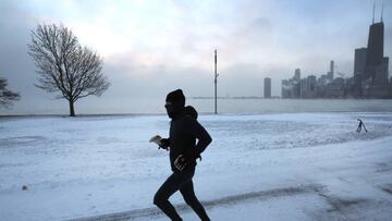 CHICAGO, ILLINOIS - DECEMBER 23: A jogger runs along Lake Michigan at sunrise as temperatures hover about -8 degrees on December 22, 2022 in Chicago, Illinois. Sub-zero temperatures are expected to grip the city for the next couple of days with wind chill temperature dipping as low as -40 degrees. (Photo by Scott Olson/Getty Images)