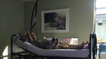 Jan Bakelants posa sobre una camilla en su casa acompañado de su bebé tras la dura caída que sufrió en el Giro de Lombardía.