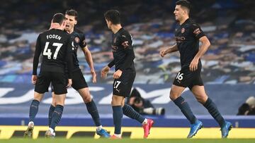 LIVERPOOL, ENGLAND - FEBRUARY 17: Phil Foden of Manchester City celebrates with team mates (L - R) Ruben Dias, Rodrigo and Joao Cancelo after scoring their side's first goal during the Premier League match between Everton and Manchester City at Goodi
