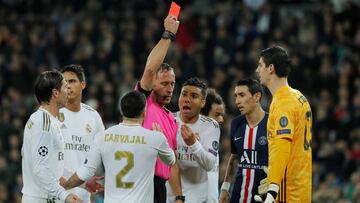 Soccer Football - Champions League - Group A - Real Madrid v Paris St Germain - Santiago Bernabeu, Madrid, Spain - November 26, 2019 Real Madrid's Thibaut Courtois is shown a red card by referee Artur Soares Dias before the decision is reversed foll