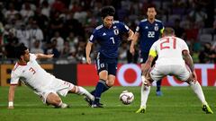 Iran&#039;s defender Ehsan Haji Safi (L) attempts a tackle on Japan&#039;s midfielder Gaku Shibasaki (C) during the 2019 AFC Asian Cup semi-final football match between Iran and Japan at the Hazza Bin Zayed Stadium in Abu Dhabi on January 28, 2019. (Photo