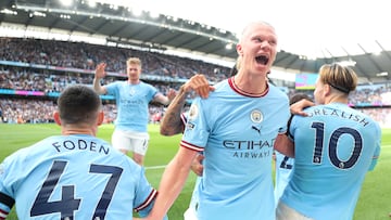 MANCHESTER, ENGLAND - OCTOBER 02: Erling Haaland of Manchester City celebrates as team mate Phil Foden scores their sides first goal during the Premier League match between Manchester City and Manchester United at Etihad Stadium on October 02, 2022 in Manchester, England. (Photo by Matt McNulty - Manchester City/Manchester City FC via Getty Images)