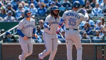 Apr 6, 2023; Kansas City, Missouri, USA; Toronto Blue Jays first baseman Vladimir Guerrero Jr. (27) gets congratulated by second baseman Whit Merrifield (15) after scoring during the first inning against the Kansas City Royals at Kauffman Stadium. Mandatory Credit: William Purnell-USA TODAY Sports