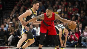 Feb 14, 2018; Portland, OR, USA; Portland Trail Blazers guard Damian Lillard (0) dribbles the ball as he is guarded by Golden State Warriors guard Klay Thompson (11) during the first half at the Moda Center. Mandatory Credit: Troy Wayrynen-USA TODAY Sports