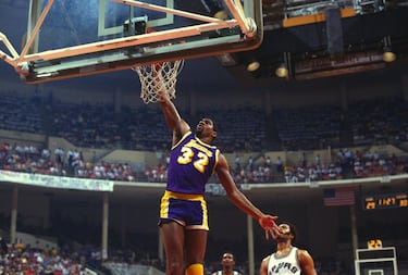 Antes de Michael Jordan, Earving ‘Magic’ Johnson y Larry Bird rescataron a una NBA en decadencia y la pusieron rumbo a su edad de oro. Magic, un base de 2,06 con una visión de juego que parecía cosa de ciencia ficción, lideró a los Lakers del Showtime que ganaron cinco anillos en los años 80 y, sobre todo, crearon un estilo de juego eléctrico e inolvidable y conectaron con la cultura de Hollywood para, desde el viejo Forum de Inglewood, convertir a los Lakers en un emblema global del deporte. Uno de los jugadores con más carisma que jamás ha pisado una cancha de baloncesto, ya era sensación en Michigan State cuando jugó (y ganó) en 1979 la final universitaria más mediática de la historia contra la Indiana State de, cómo no, Larry Bird. Promedió 11,2 asistencias en una carrera truncada en su última fase por el VIH contra el que luego hizo una campaña de concienciación que los expertos consideraron clave para romper tabús en la sociedad estadounidense. Ahora un empresario de enorme éxito, el apodo de ‘Magic’ nació cuando todavía jugaba en instituto y se lo puso el periodista Fred Stabley, del ‘Lansing State Journal’: "Necesitas un apodo y si te parece bien, te voy a llamar Magic". Acababa de firmar 36 puntos, 18 rebotes y 16 asistencias.