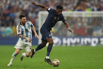 Argentina's forward #10 Lionel Messi (L) fights for the ball with France's midfielder #08 Aurelien Tchouameni (R) during the Qatar 2022 World Cup final football match between Argentina and France at Lusail Stadium in Lusail, north of Doha on December 18, 2022. (Photo by Adrian DENNIS / AFP)