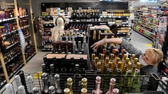 An employee arranges bottles of sparkling wine at a supermarket in Moscow on December 15, 2021.
