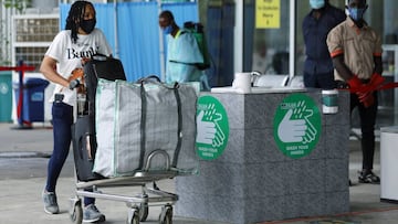 A passenger wearing a face mask pushes a trolley outside the Nnamdi Azikiwe International Airport, on its re-opening day for domestic flight operations, following the coronavirus disease (COVID-19) outbreak, in Abuja, Nigeria July 8, 2020. REUTERS/Afolabi