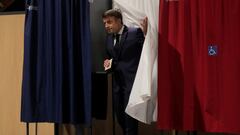 French President Emmanuel Macron walks out of a voting booth during the final round of the country's parliamentary elections, in Le Touquet, France June 19, 2022 Michel Spingler/Pool via REUTERS