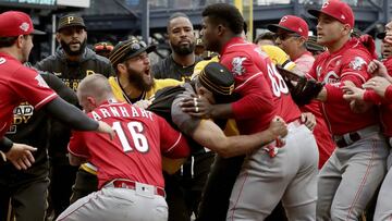 Cincinnati Reds' Yasiel Puig (66) is restrained by Pittsburgh Pirates bench coach Tom Prince, in the middle of a bench clearing brawl during the fourth inning of a baseball game in Pittsburgh, Sunday, April 7, 2019. (AP Photo/Gene J. Puskar)