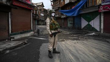 A security personnel stands guard on a street near the grand mosque, Jamia Masjid, as strict restrictions have been imposed amid concerns over the spread of the COVID-19 coronavirus for the Muslim festival of Eid al-Adha, the feast of sacrifice, in Srinag