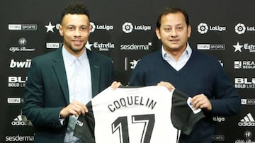 Coquelin, who has taken the number 17 shirt, poses with Valencia president Anil Murthy at his unveiling.