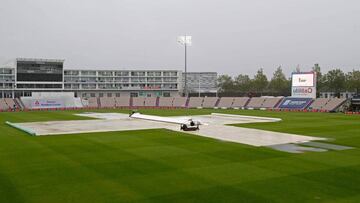 Puddles form on the field near the covers, as rain stops play on the fourth day of the third Test cricket match between England and Pakistan at the Ageas Bowl in Southampton, southern England on August 24, 2020. (Photo by Alastair Grant / POOL / AFP) / RE