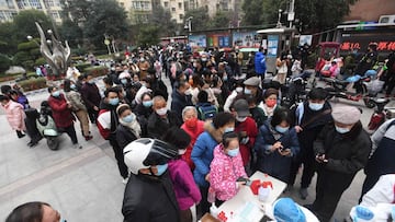 Residents queue to undergo nucleic acid tests for the Covid-19 coronavirus in Wuhan in China's central Hubei province on February 22, 2022. (Photo by AFP) / China OUT