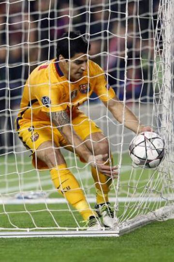 Barcelona's Uruguayan forward Luis Suarez grabs the ball after scoring the equaliser. He's keen to get the game back on.