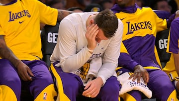 Mar 19, 2025; Los Angeles, California, USA; Los Angeles Lakers guard Luka Doncic (77) holds his face on the bench after getting fouled against the Denver Nuggets at Crypto.com Arena. Mandatory Credit: Jayne Kamin-Oncea-Imagn Images
