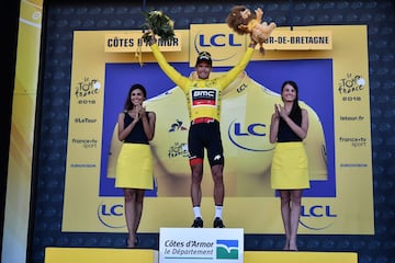 El ciclista del equipo BMC Racing Team, Greg Van Avermaet celebra en el podio, luciendo la camiseta amarilla de líder.