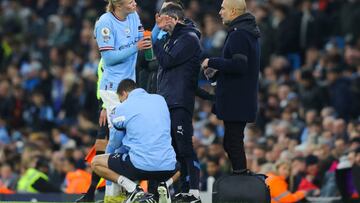 Erling Haaland is treated by the Manchester City medical services during the match against Aston Villa.