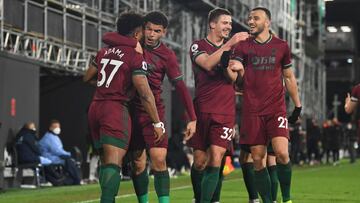LONDON, ENGLAND - APRIL 09: Adama Traore of Wolverhampton Wanderers celebrates with Morgan Gibbs-White, Leander Dendoncker and Romain Saiss and teammates after scoring their team's first goal during the Premier League match between Fulham and Wolverh