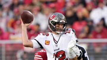 SANTA CLARA, CALIFORNIA - DECEMBER 11: Tom Brady #12 of the Tampa Bay Buccaneers throws the ball while being pressured by Jordan Willis #75 of the San Francisco 49ers during the third quarter of the game at Levi's Stadium on December 11, 2022 in Santa Clara, California.   Thearon W. Henderson/Getty Images/AFP (Photo by Thearon W. Henderson / GETTY IMAGES NORTH AMERICA / Getty Images via AFP)