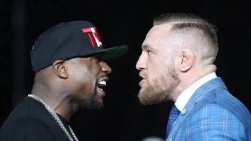 Floyd Mayweather and Conor McGregor stare each other down during a world tour press conference to promote the upcoming Mayweather vs McGregor boxing fight at Budweiser Stage.