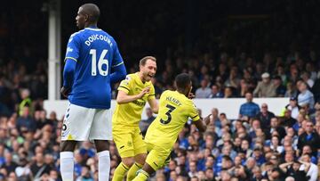 Brentford's English defender Rico Henry (R) celebrates with Brentford's Danish midfielder Christian Eriksen (C) after scoring his team third goal during the English Premier League football match between Everton and Brentford at Goodison Park in