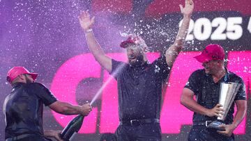 Aug 24, 2025; Detroit, Michigan, USA; Tyrrell Hatton, left, and Jon Rahmm, middle, and Caleb Surratt of Legion XIII celebrate with the trophy after the finals of the LIV Golf Michigan Team Championship at The Cardinal at Saint John's Resort. Mandatory Credit: Aaron Doster-Imagn Images