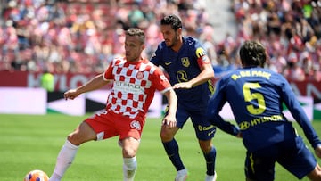 Girona's Brazilian midfielder #12 Arthur Henrique Ramos fights for the ball with Atletico Madrid's Spanish midfielder #06 Koke during the Spanish league football match between Girona FC and Club Atletico de Madrid at Montilivi Stadium in Girona, on May 25, 2025. (Photo by Josep LAGO / AFP)